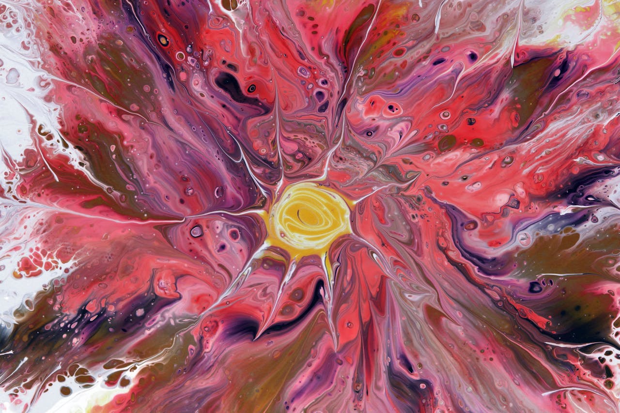 Abstract fluid art design with red, pink, and yellow swirls resembling a flower bloom, vibrant and dynamic.